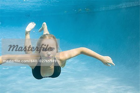 Portrait of a teenage girl swimming underwater, Stock Photo