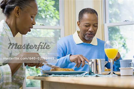 Senior man and a senior woman having breakfast