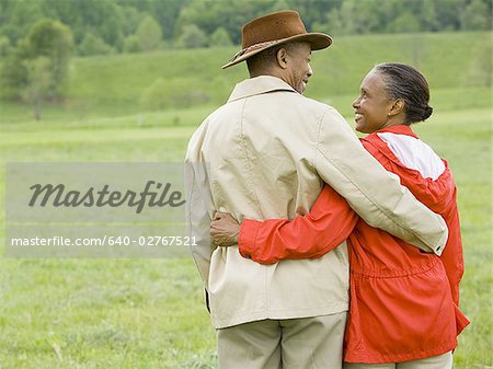 Rear view of a senior man and a senior woman with their arms around each other