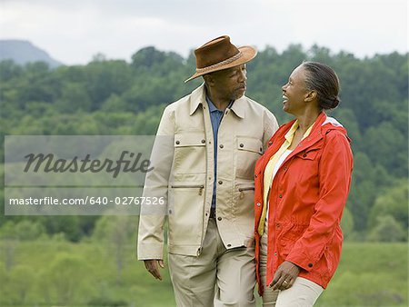 Senior man and a senior woman walking in a field