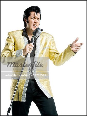 Close-up of an Elvis impersonator singing into a microphone