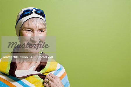 Close-up of a senior woman wearing a swimming cap and swimming goggles