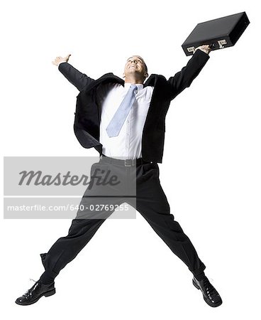 Businessman jumping with briefcase