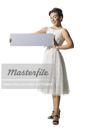 Woman in white dress holding a blank sign