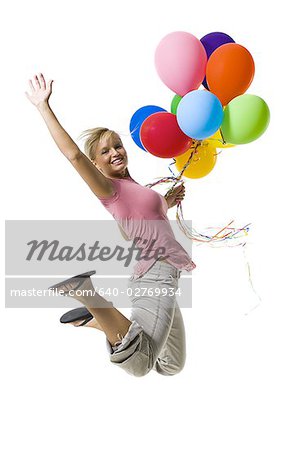 Woman with balloons jumping