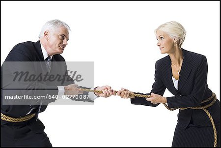 Businessman and businesswoman in a tug of war