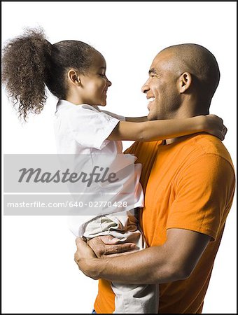 Father holding young daughter