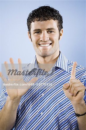 Man smiling peace sign