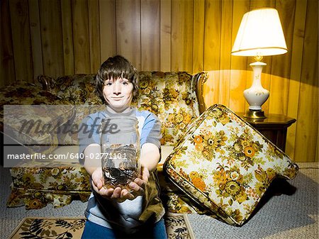Boy with coin jar smiling