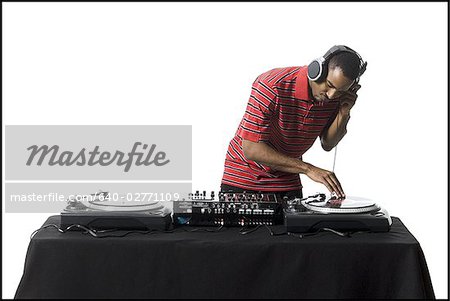 DJ with headphones spinning records DJ with headphones spinning records