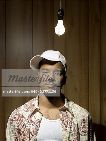 Man standing under light bulb