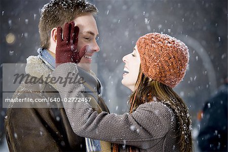 Man and woman outdoors in winter smiling