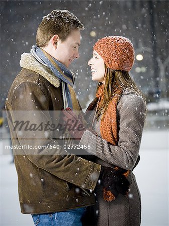Couple embracing outdoors in winter
