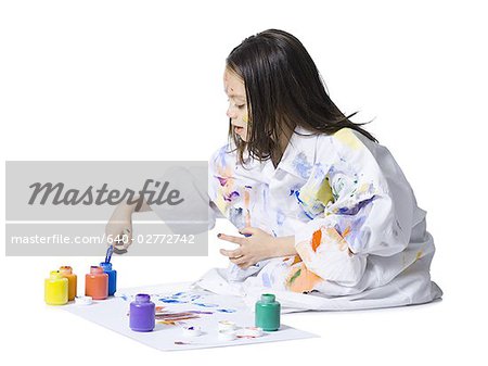 Young girl finger painting