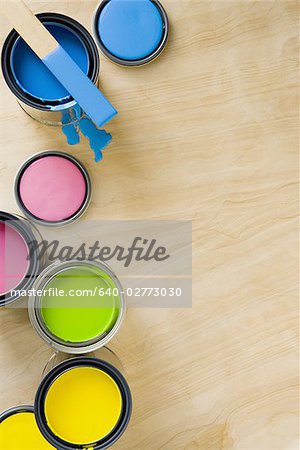 Overhead view of paint cans and stir stick