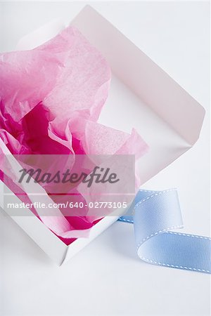 Empty candy box with tissue and ribbon