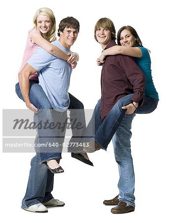 Man giving boy piggyback ride Man giving boy piggy back ride against white  background, model