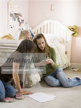 Three girls in bedroom with mp3 player