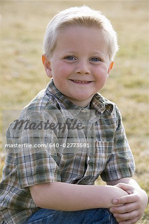 Portrait of a boy smiling outdoors