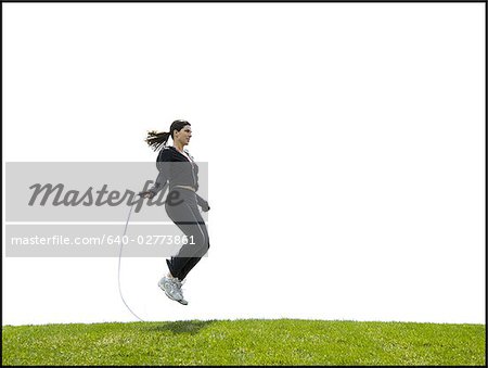 Woman skipping rope outdoors