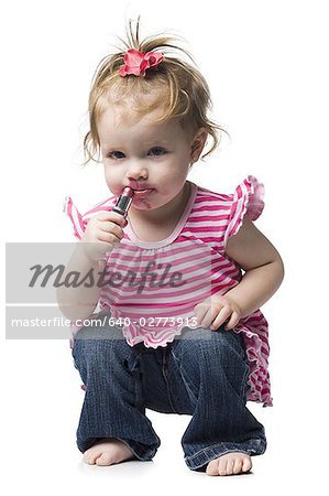 Young girl with lipstick on face