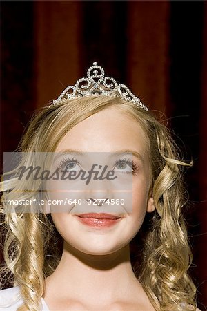 Closeup of girl with tiara looking up smiling
