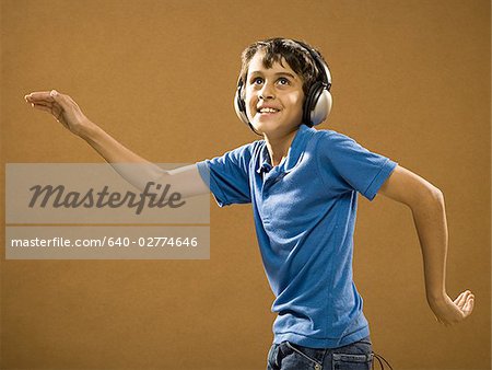 Boy with headphones smiling and waving hands