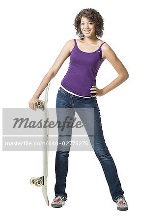 Girl standing and holding skateboard