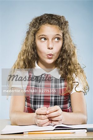 Girl sitting at desk with workbook