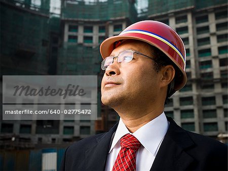 Businessman with construction helmet outdoors