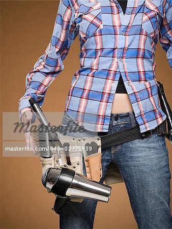 Mid section view of hairdresser with tool belt