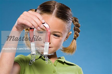 Child holding a magnet.