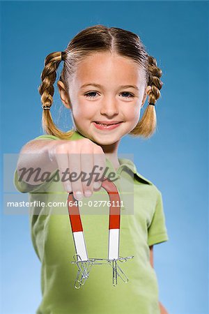 Child holding a magnet.