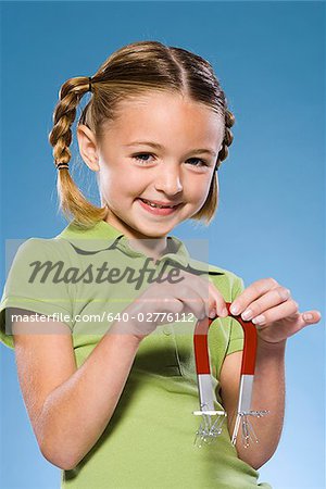 Child holding a magnet.