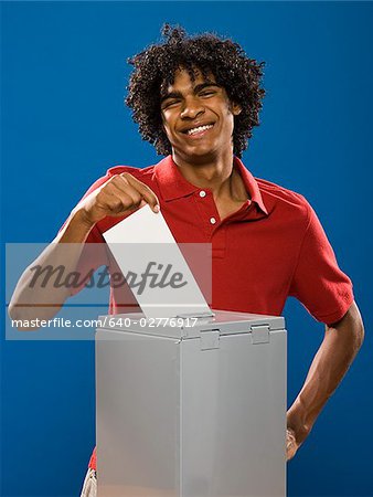 young man casting a ballot.