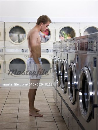 Man taking off underpants Stock Photos - Page 1 : Masterfile