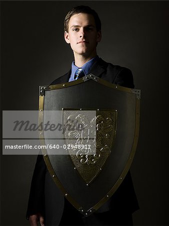 businessman holding a shield