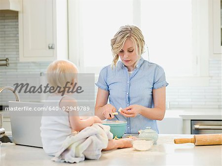 mother and baby girl cooking in the kitchen