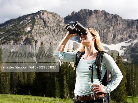 female hiker with binoculars