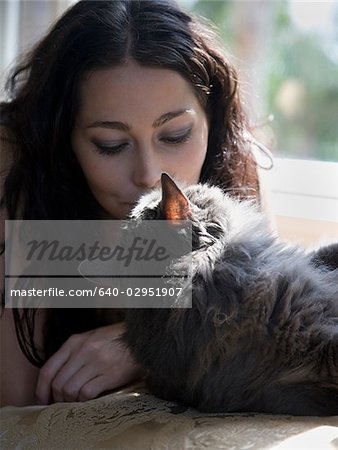 woman on a window bench with her cat