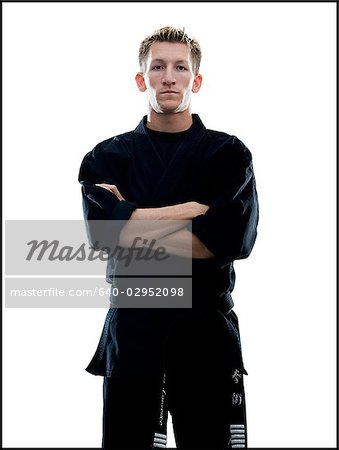 man standing in a black karate gi with arms crossed