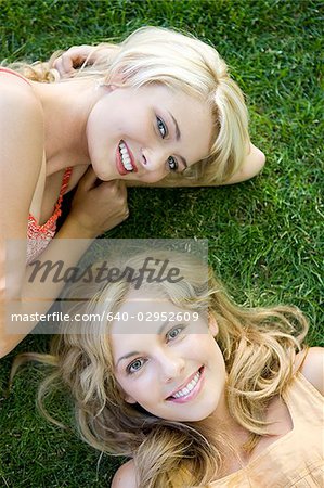 two women lying on the grass