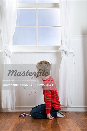 child drawing on the wall