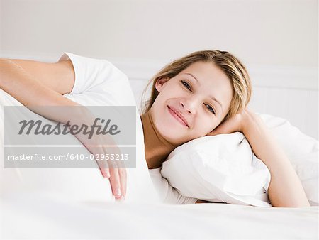 pregnant woman lying in bed on her side