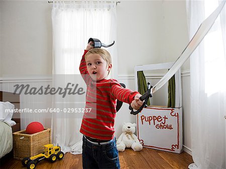 boy pretending to be a pirate in his bedroom