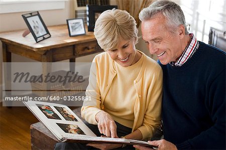 Mature couple looking at photo album