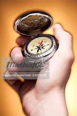 Hand holding compass