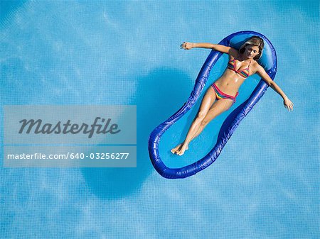 Woman relaxing on pool lounger