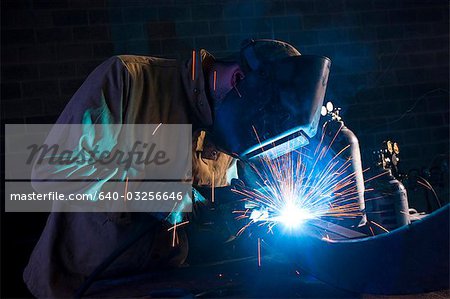 USA, Utah, Orem, man welding metal in workshop