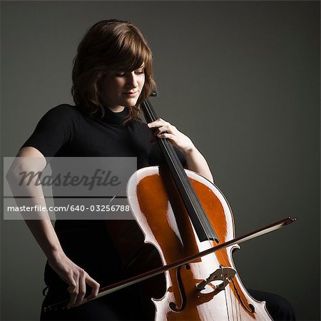 Young woman playing cello, studio shot